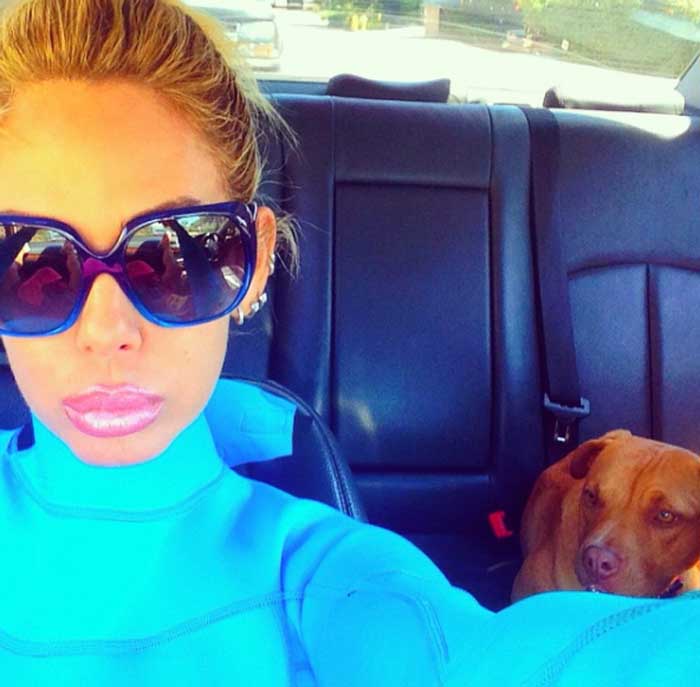 Shauna Sand taking a selfie with her pooch inside car.